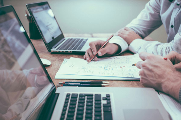 Professionals reviewing records and compliance documents